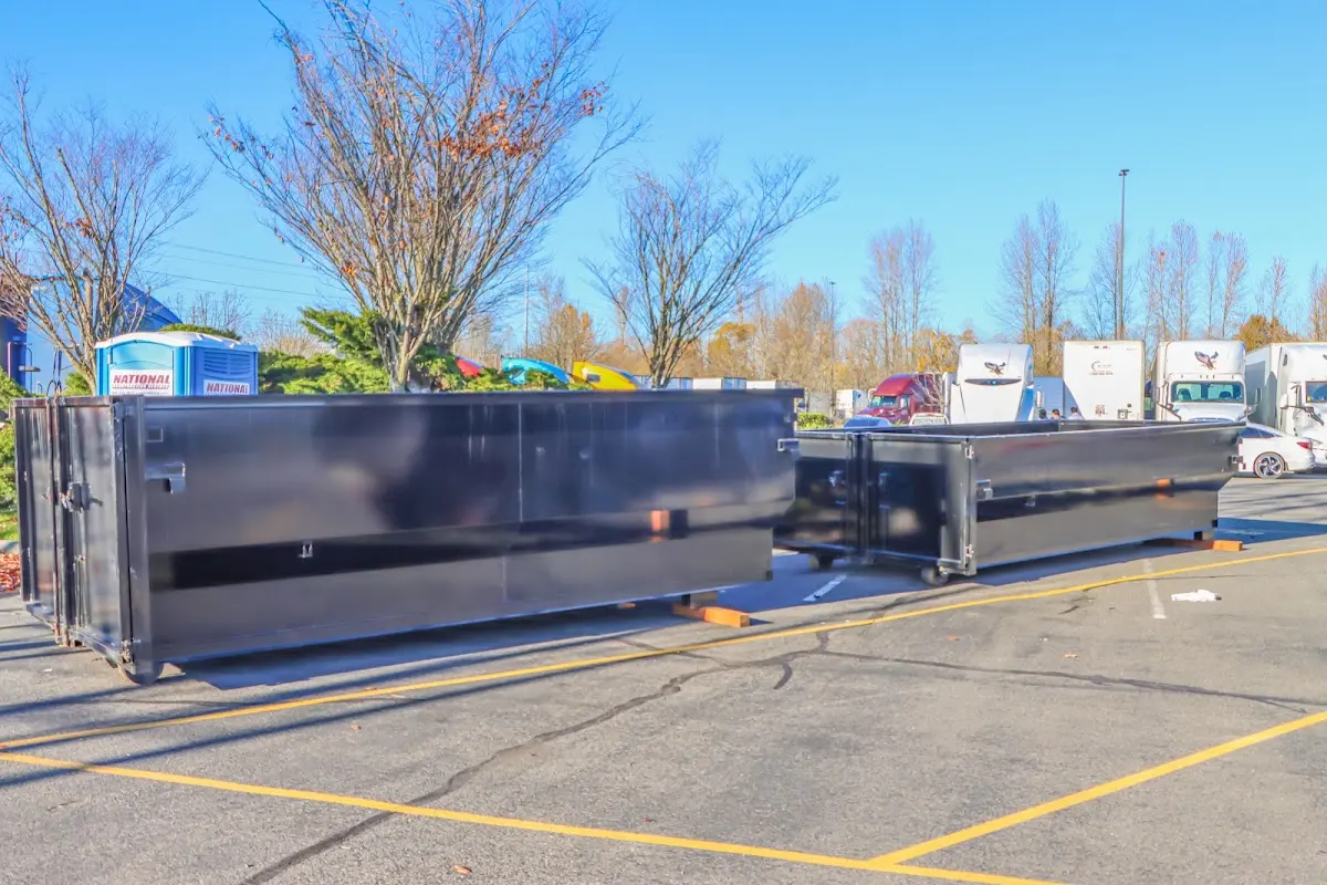 Professional dumpster rental service with roll-off container on residential driveway in Round Rock